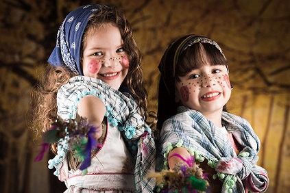 two kids dressed as witches with pink cheeks